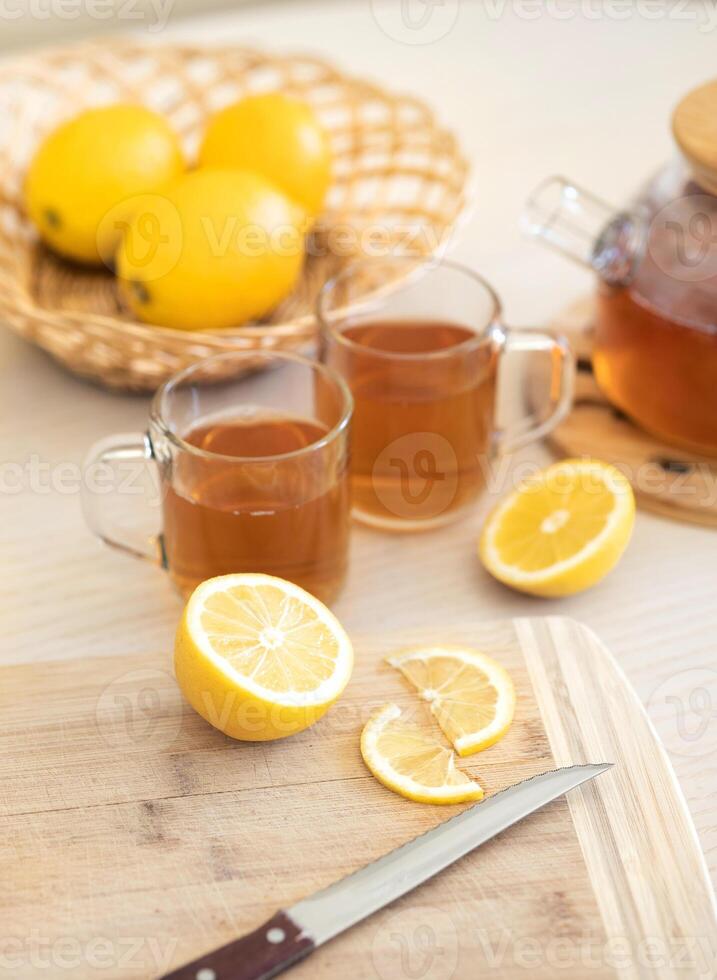 Fresh lemon and lemon tea in wooden dish photo