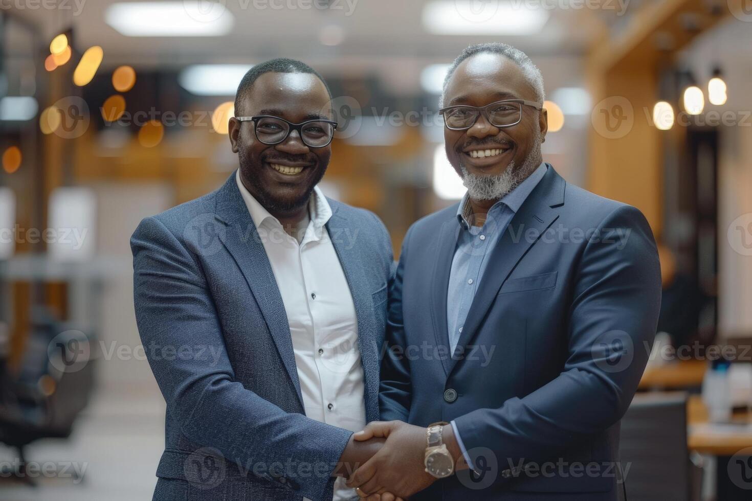 Two professional business men executive leaders shaking hands at office meeting, photo