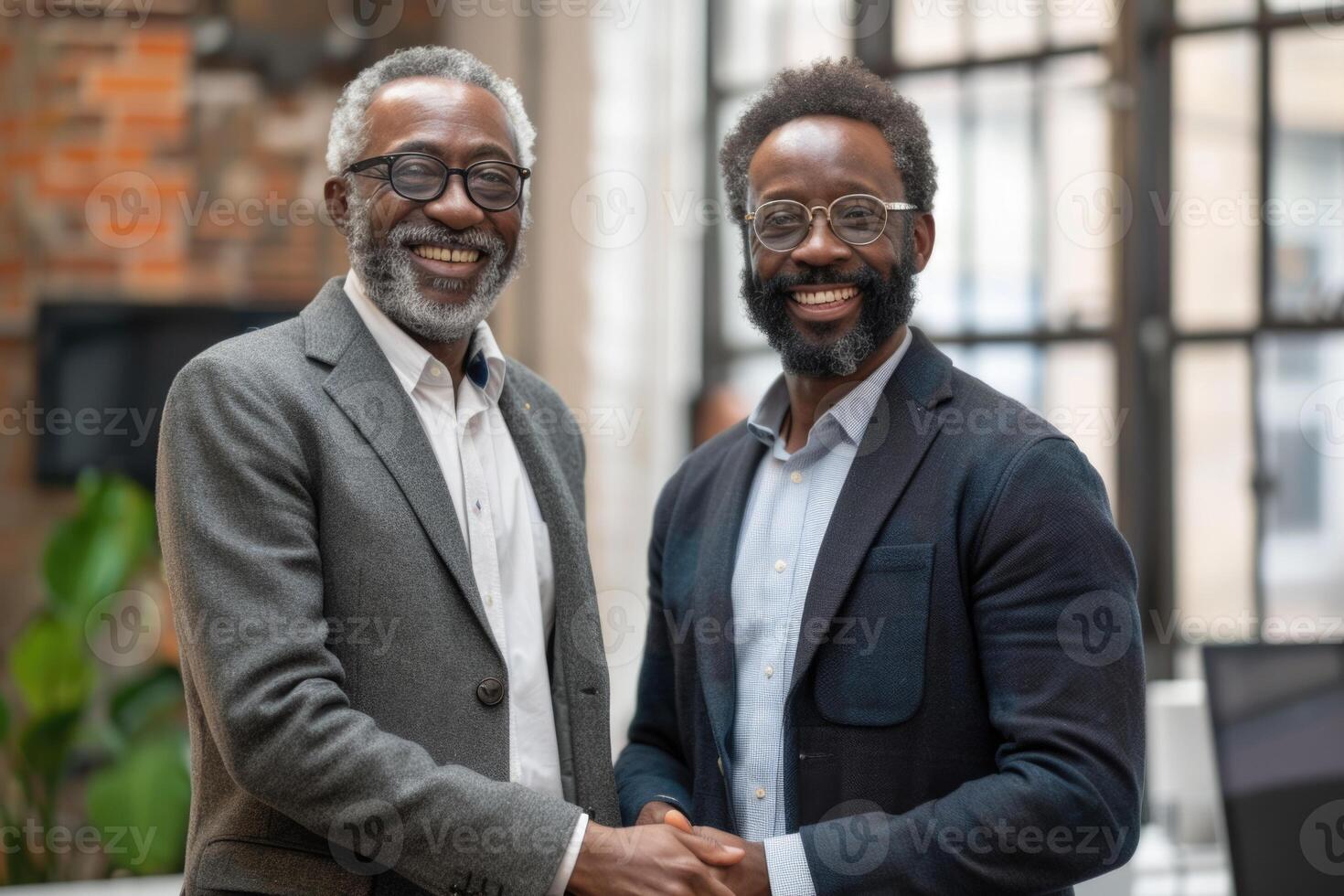 Two professional business men executive leaders shaking hands at office meeting, photo
