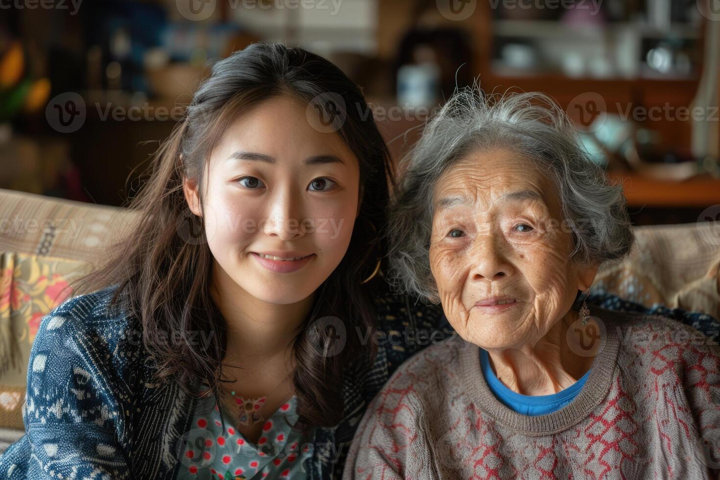 Japanese adult woman and her old mother sitting on the couch hugging. photo