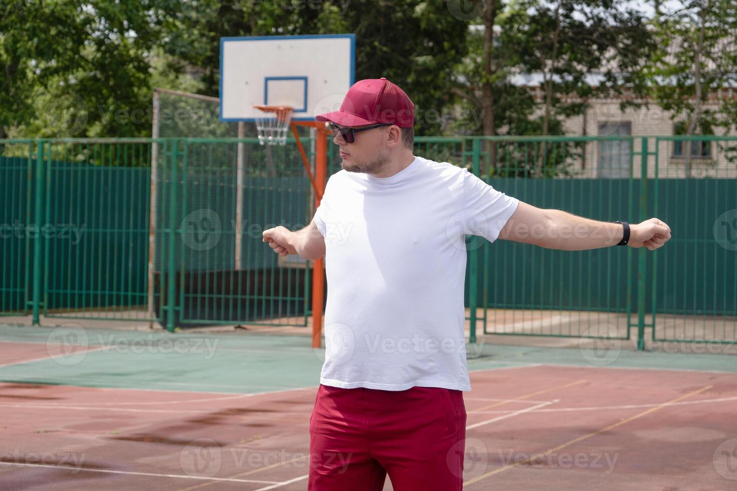 Athletic bearded man warms up before workout at the stadium photo