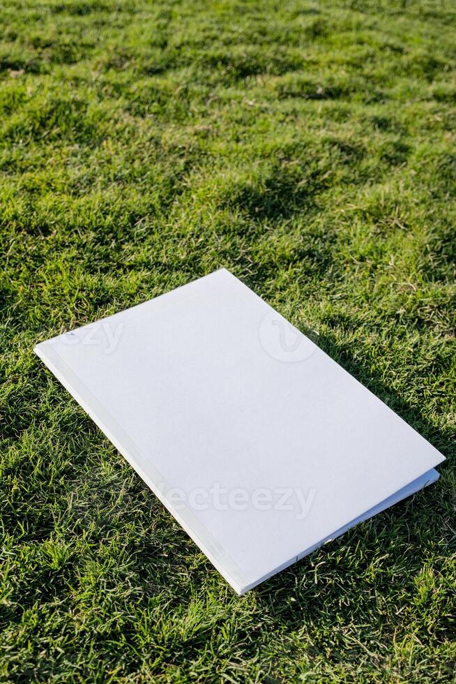 Mockup magazine on green grass background photo