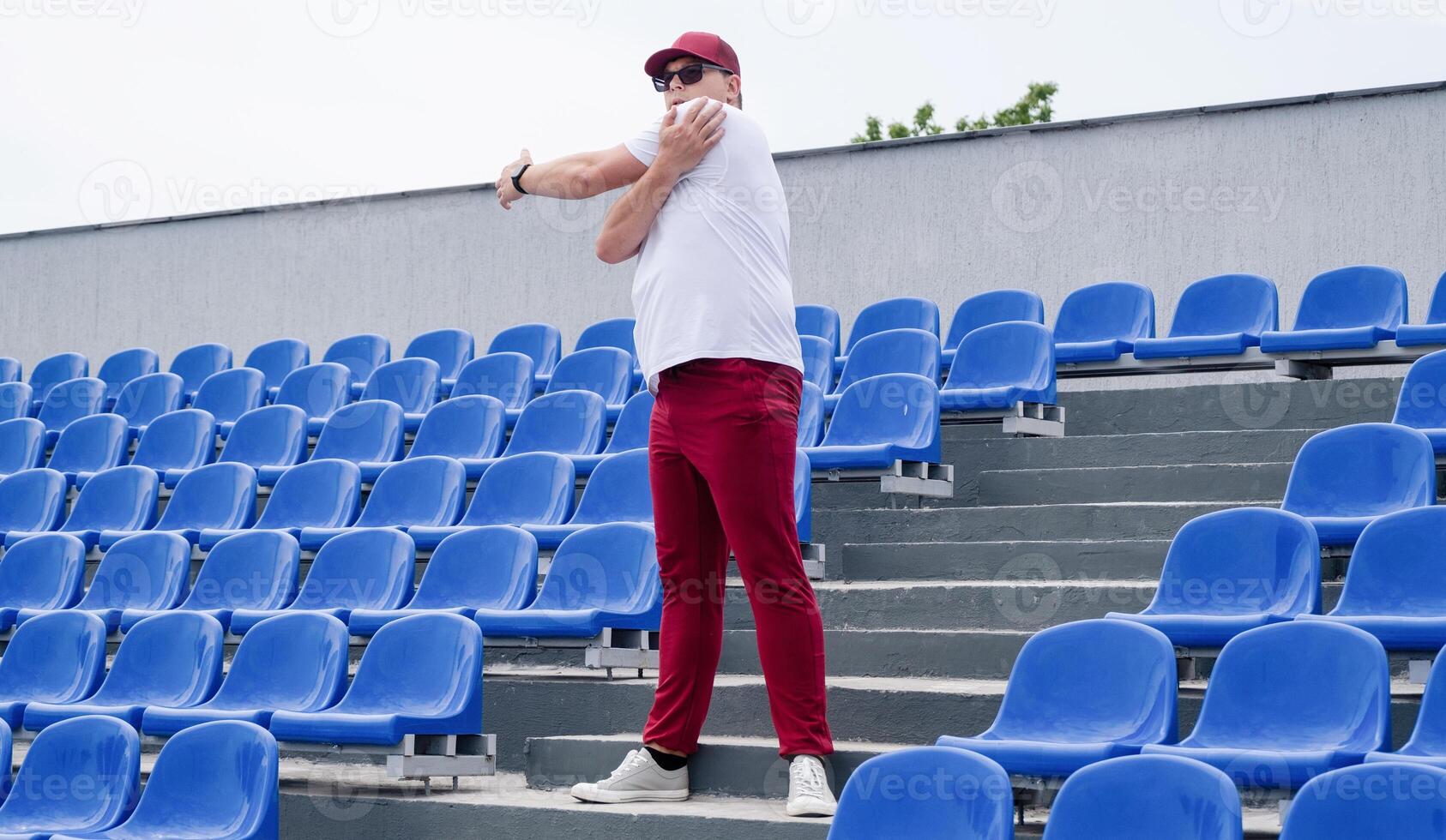 sportsman running in the stadium among blue seats photo