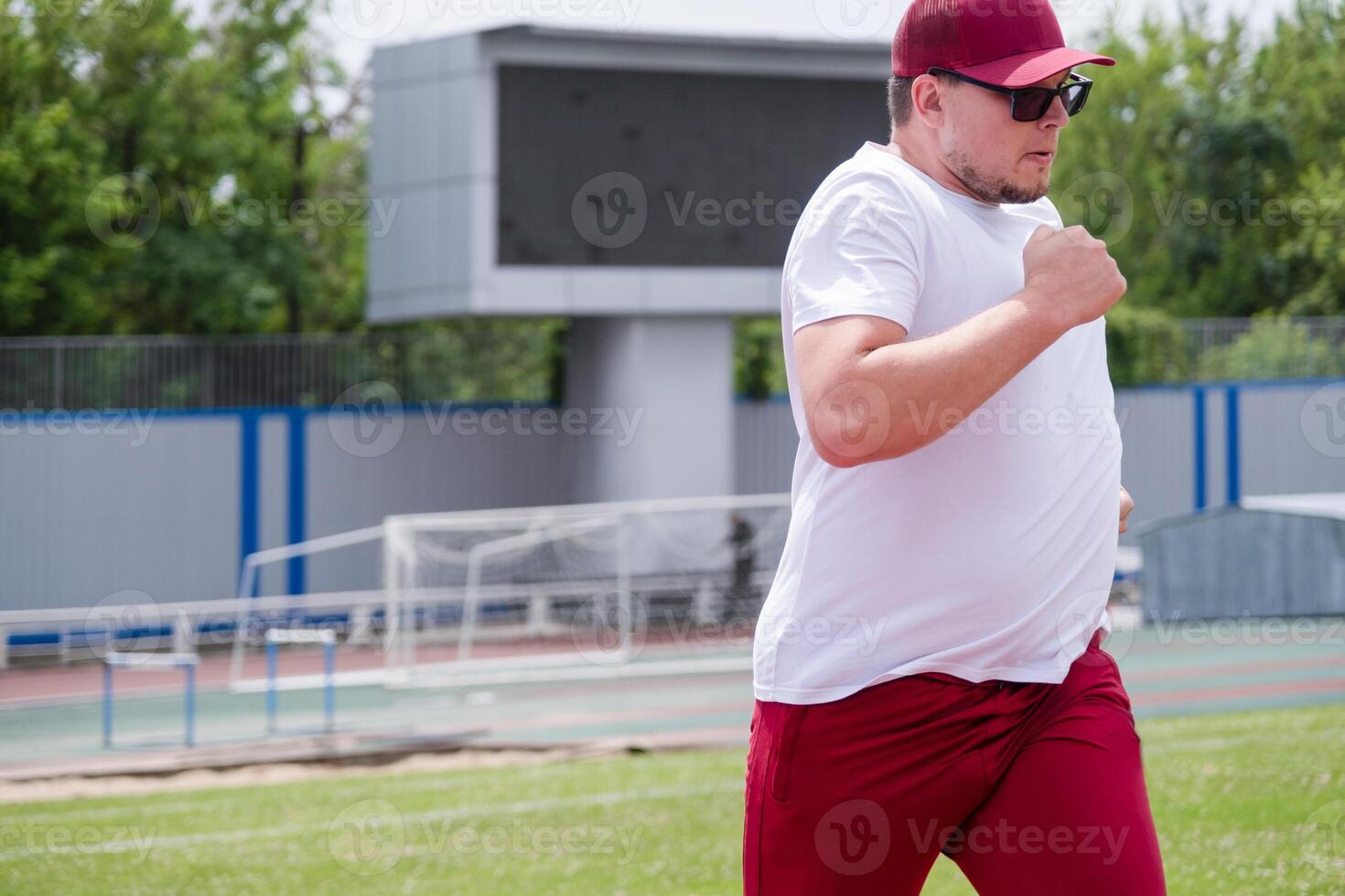 sportsman running in the stadium photo