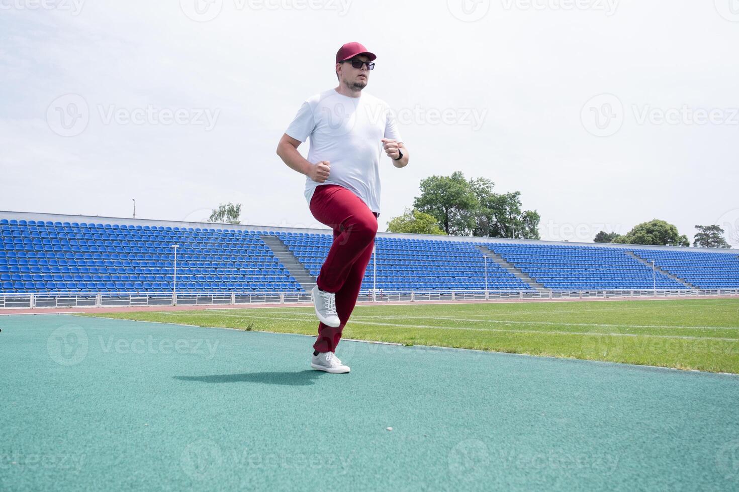 sportsman running in the stadium photo