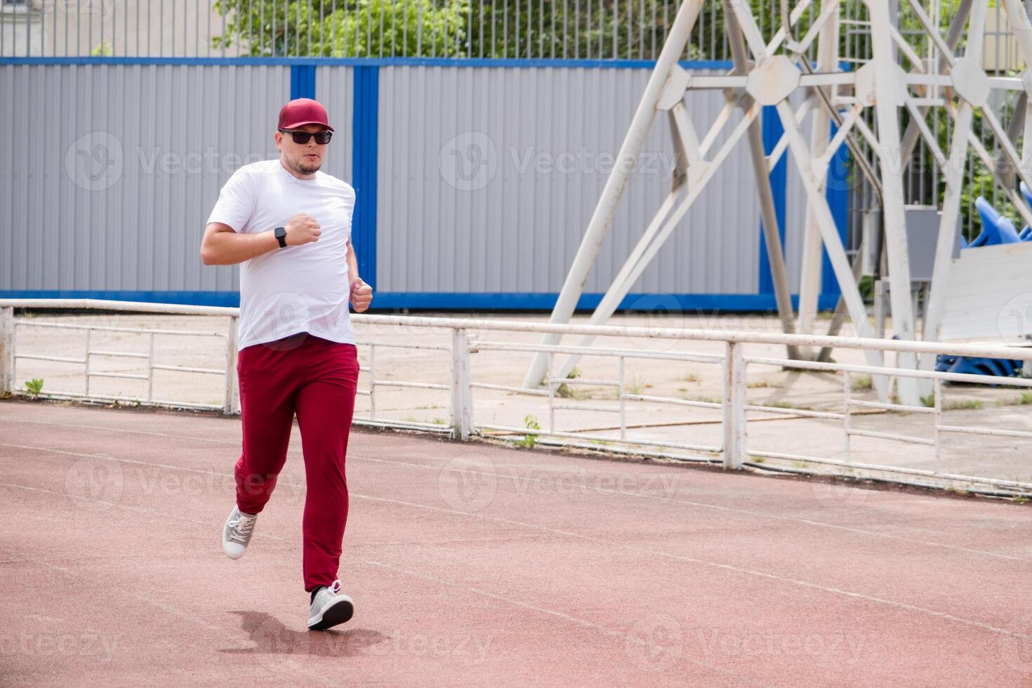 sportsman running in the stadium photo