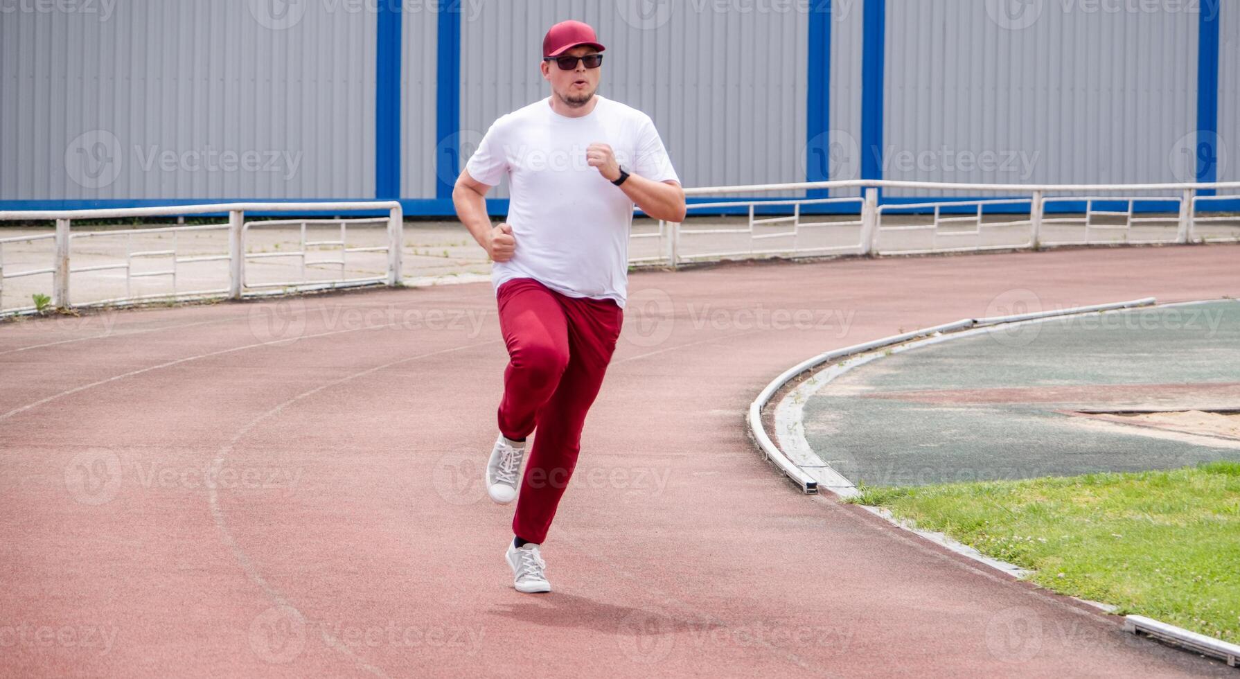 sportsman running in the stadium photo
