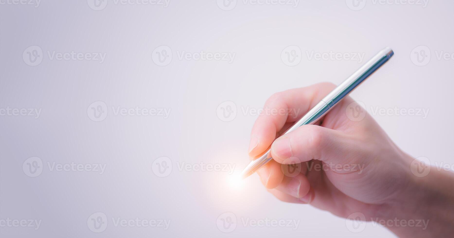 Close-up of a man's right hand holding a pen preparing to start writing or signing on the white background, the concept of signing a document or accepting an agreement with digital technology. photo