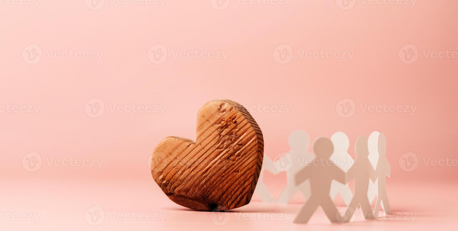 Love, Community and Unity Concepts. Social Cooperation. Organization or Charity. Paper cut as People Holding Hands Together to Protect a Big Heart. photo