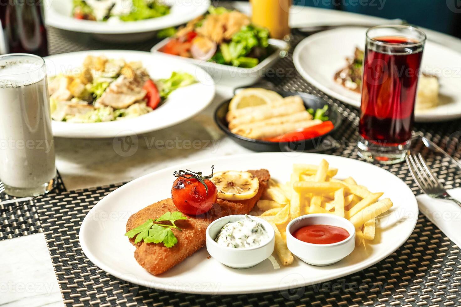 Table With Assorted Food and Beverage Plates photo