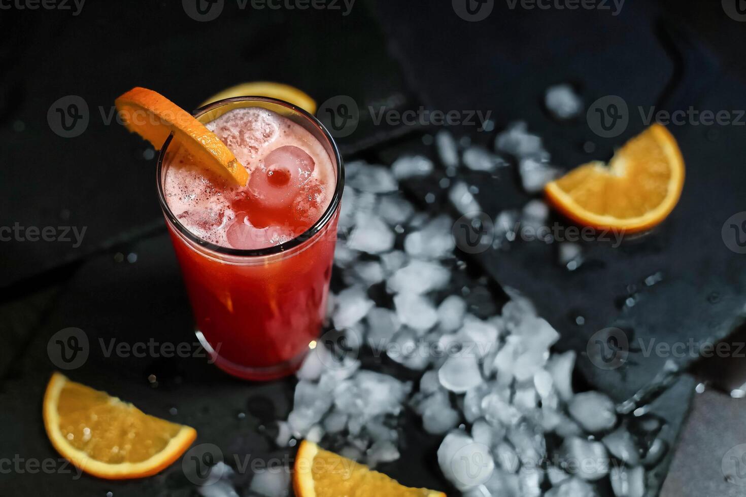 Refreshing Red Drink With Orange Garnish and Ice photo