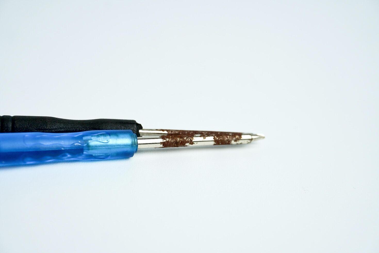 Small rusty old and aged iron screwdriver repairing object isolated on horizontal ratio white background. photo