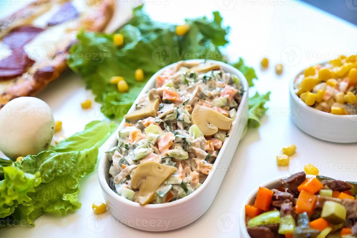 Table With Assorted Food Bowls and Fresh Salad photo