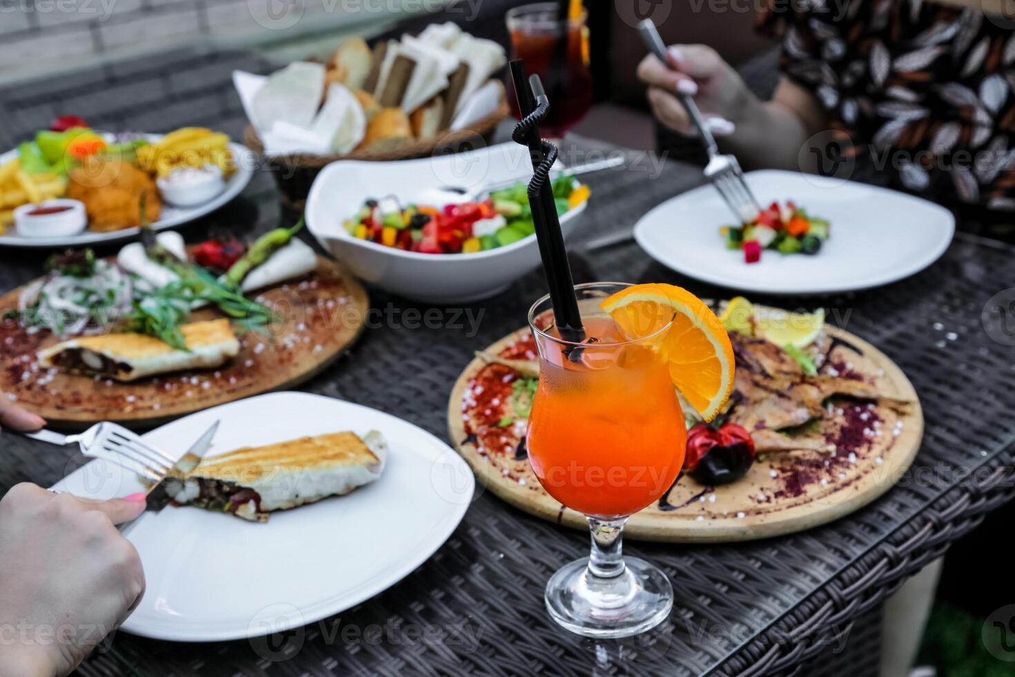 Table Adorned With Plates of Food and Drinks photo