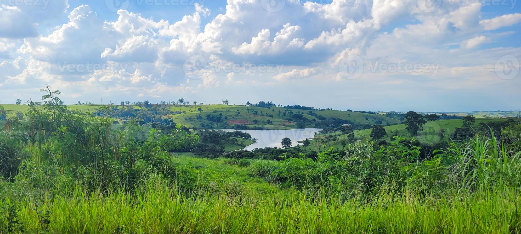 farm landscape with lake in the middle of the property photo