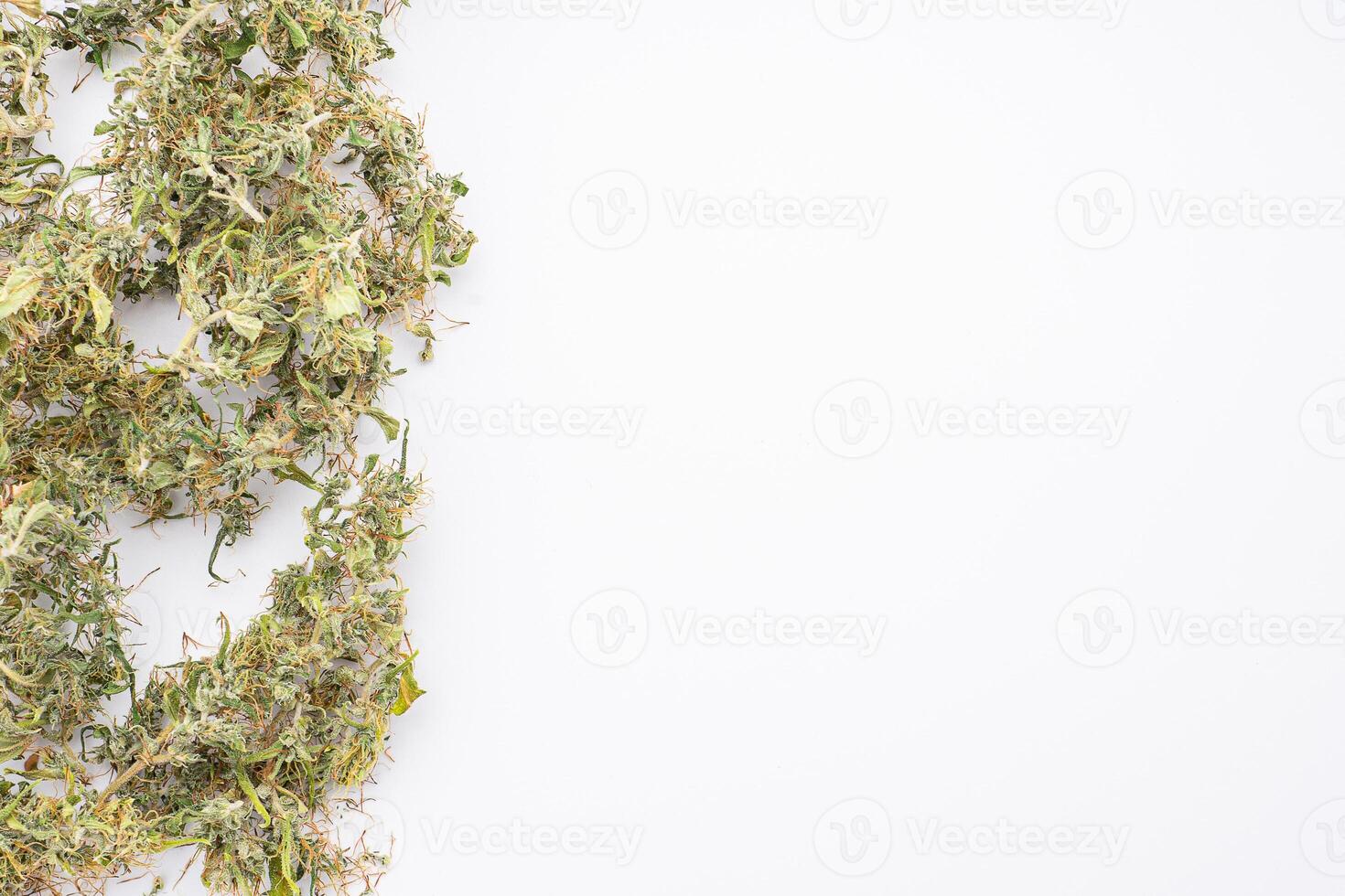 A pile of cannabis buds on white background. The texture of marijuana leaves. Space for text. Concept of cannabis plantation for medical photo