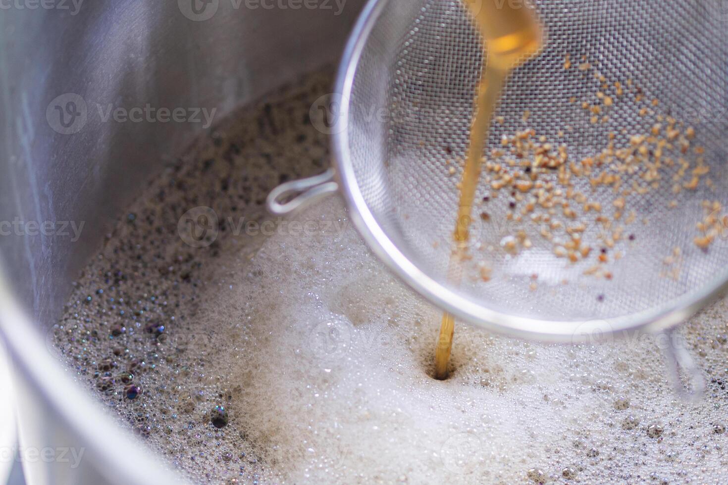 Close-up of craft beer and foam in fermentation container photo