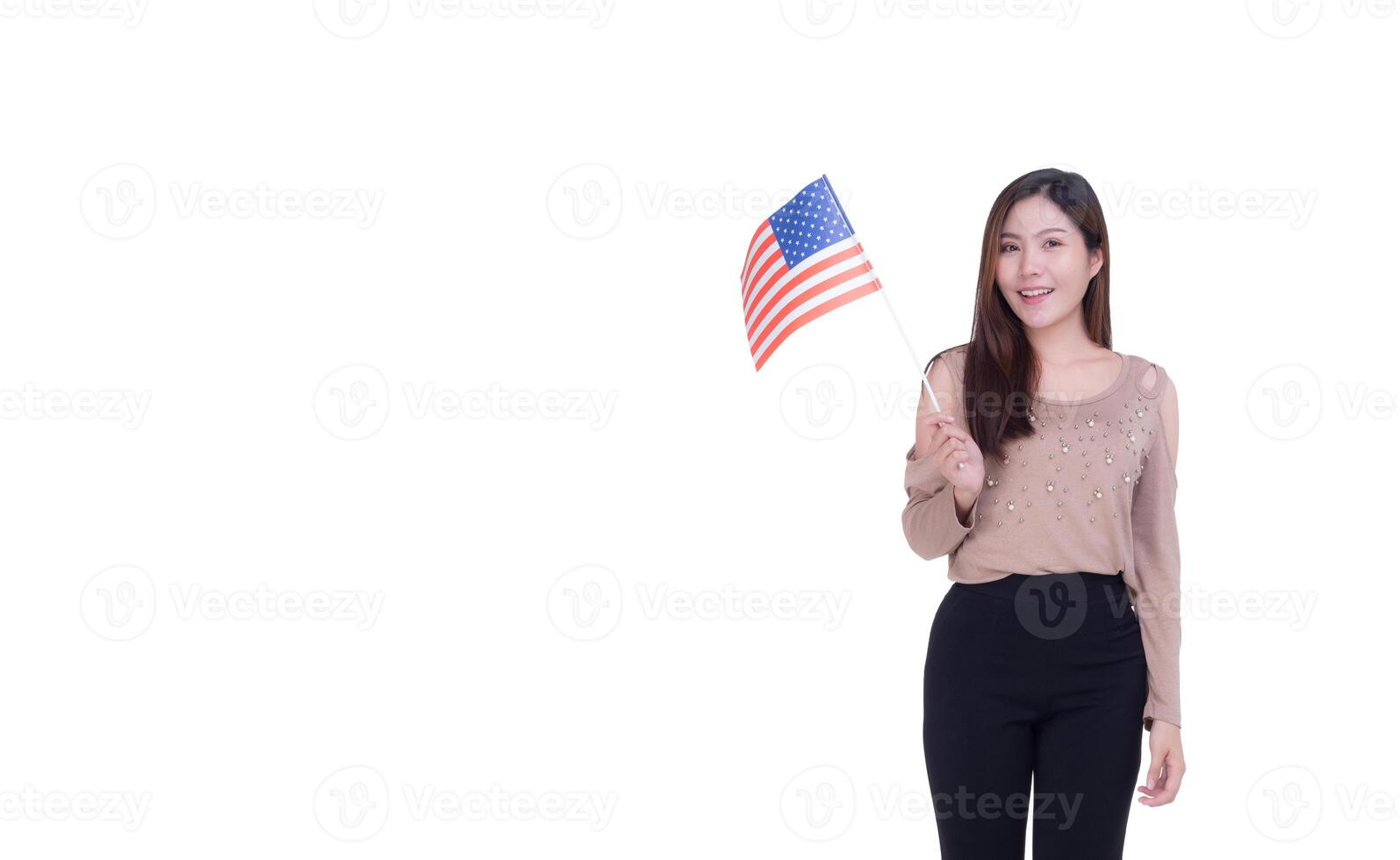 Portrait of young woman holding the USA flag while standing with white background photo