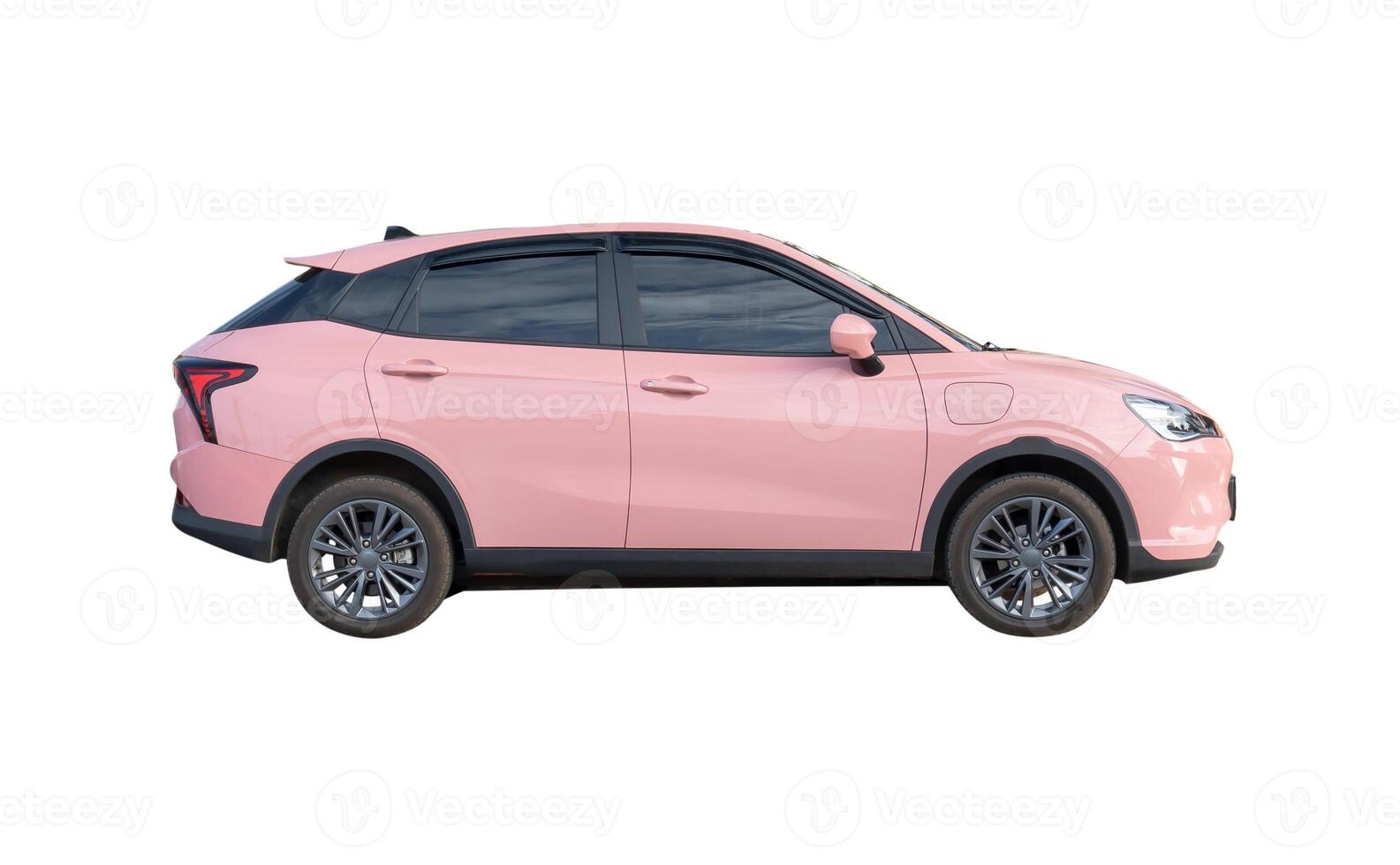 Side view of pink electric hatchback car isolated on white background with clipping path photo