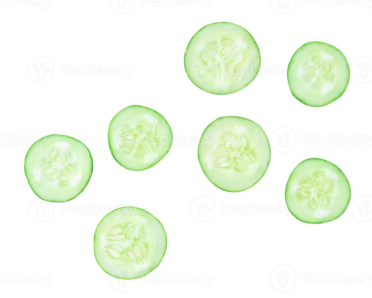 Top view set of green cucumber slices or pieces in circle shape scattering isolated on white background with clipping path photo