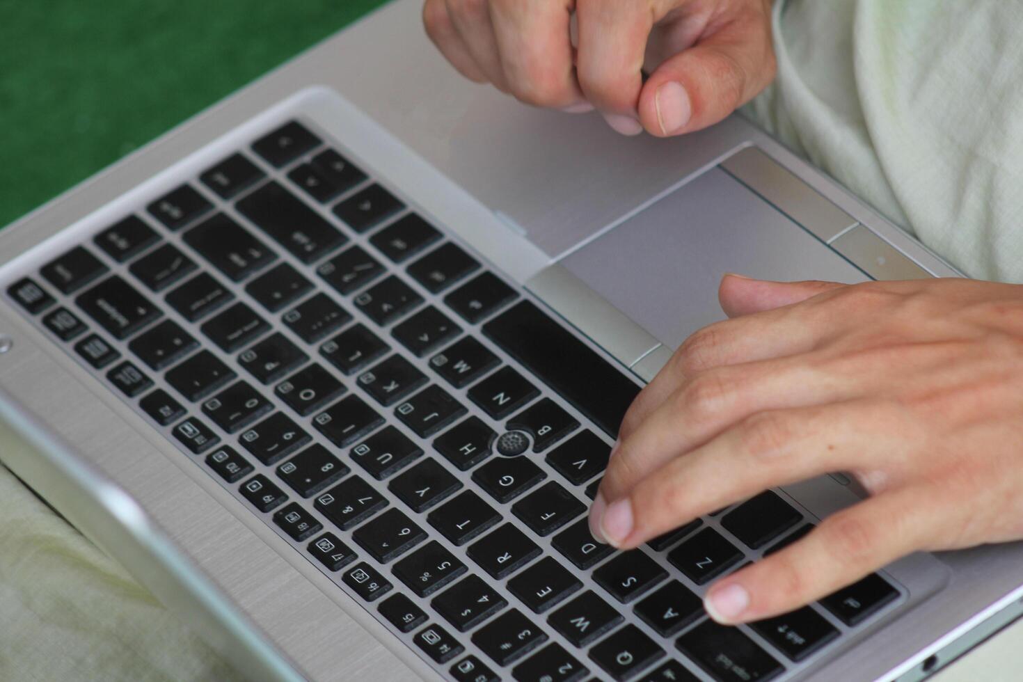Close up image of Man hands typing on laptop computer keyboard, working, business and technology, internet network communication concept photo