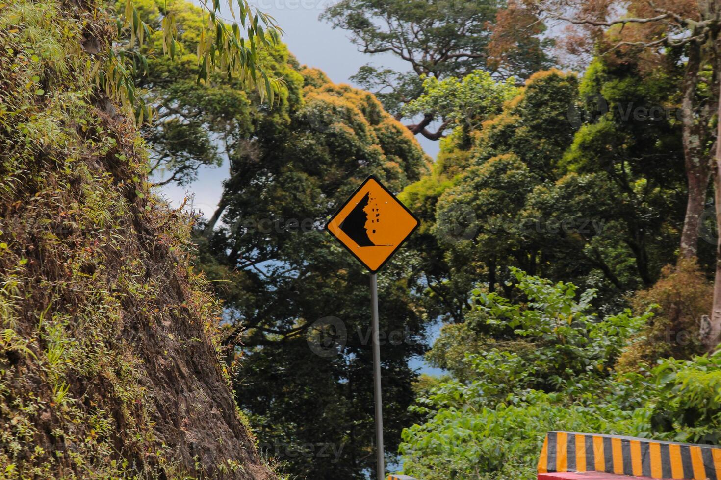 Yellow and Black landslide prone road sign photo