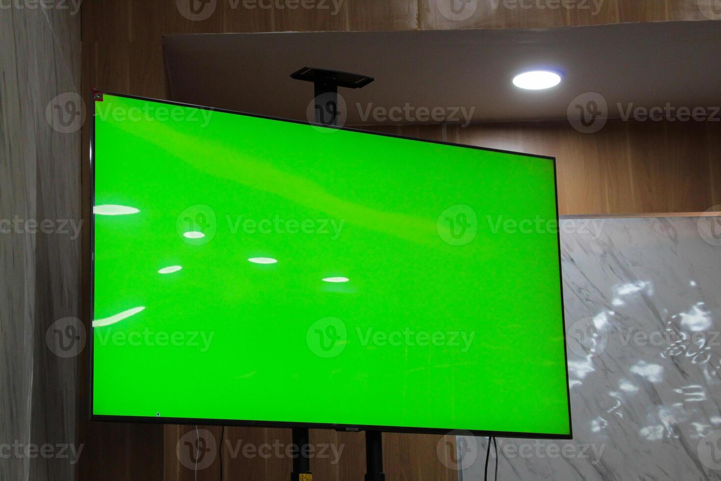 Green screen on a wide tv screen in a room photo