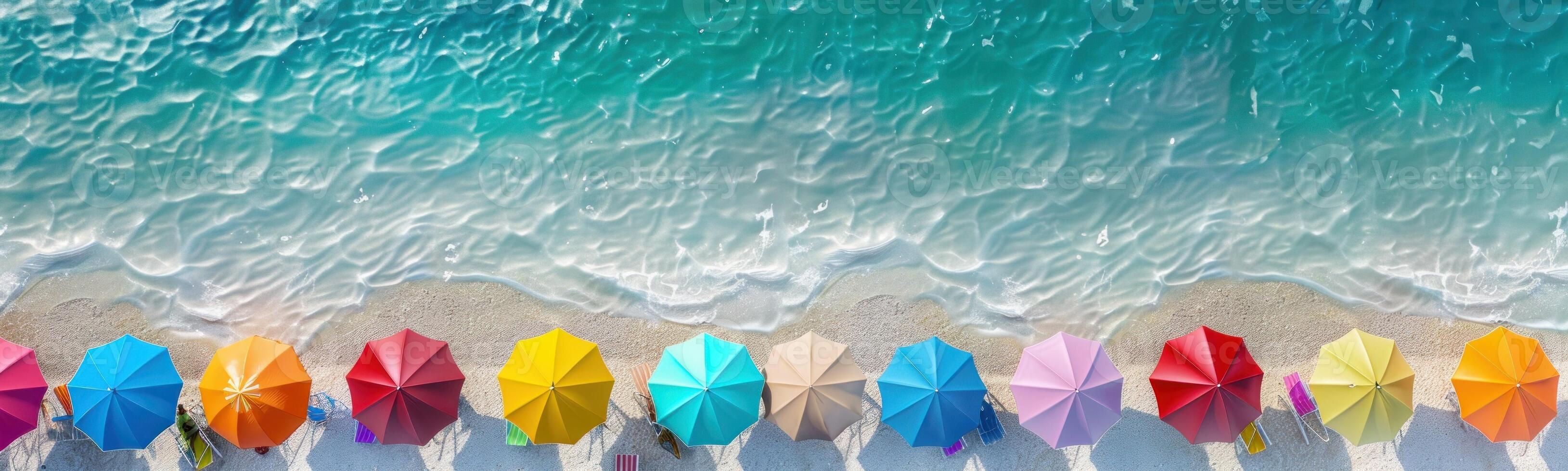 Beautiful white beach with two rows of colorful parasols. photo