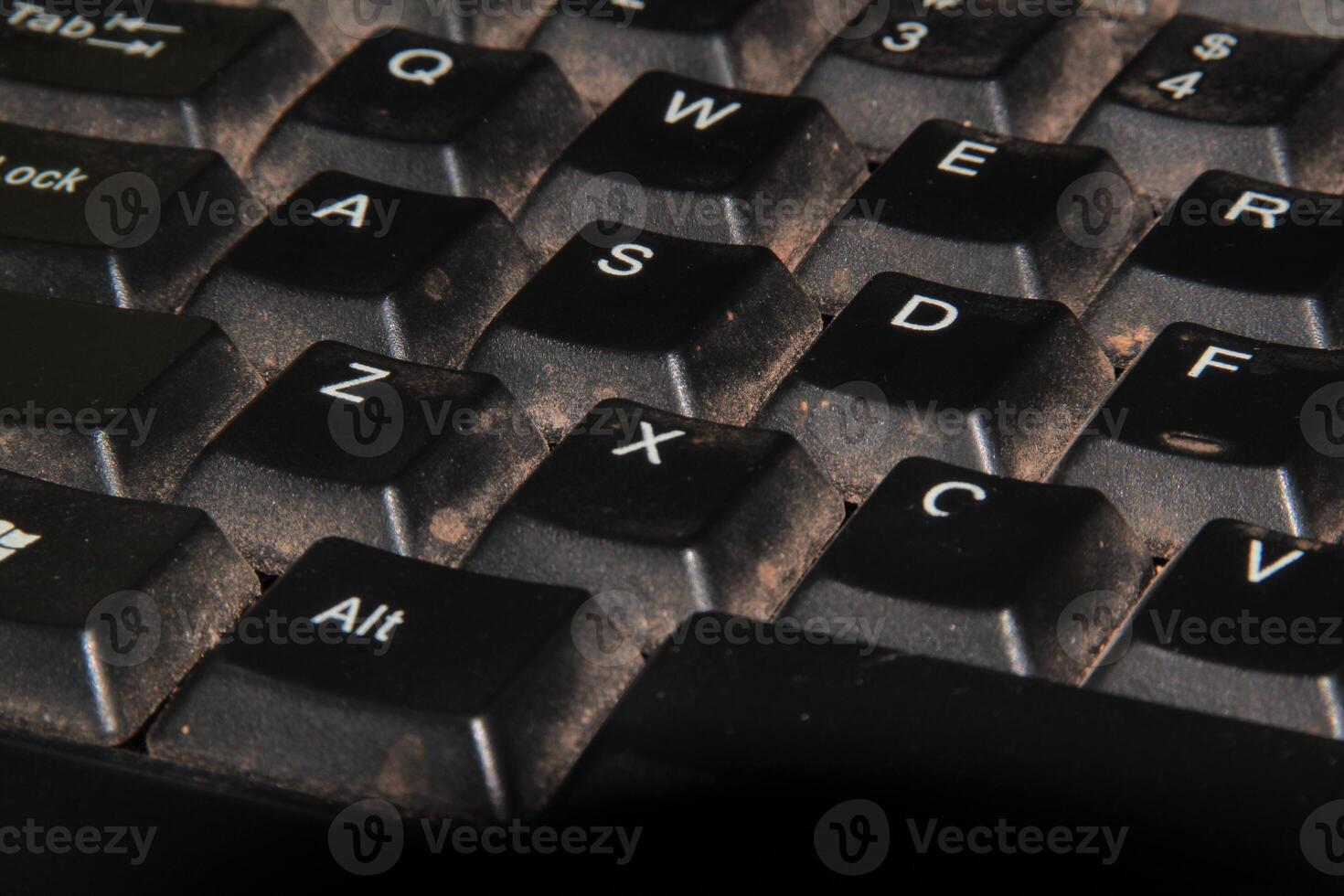 Close-Up View of a Dirty Computer Keyboard with Crumbs and Dust photo