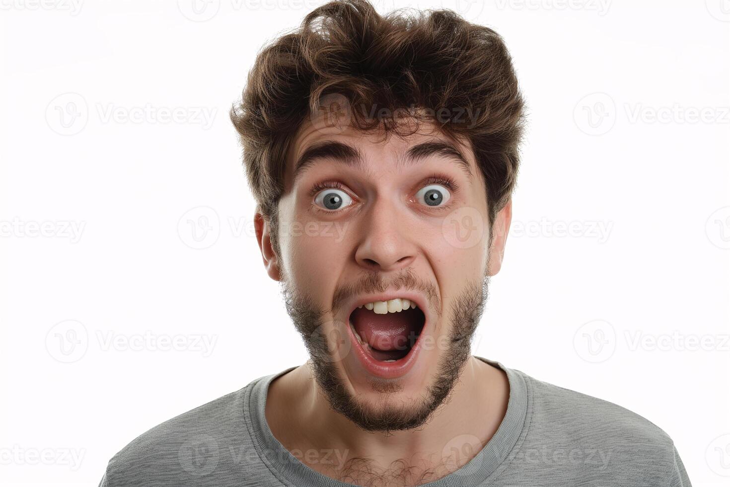 Young Man with Surprised Expression in Grey T-Shirt Isolated on White Background photo