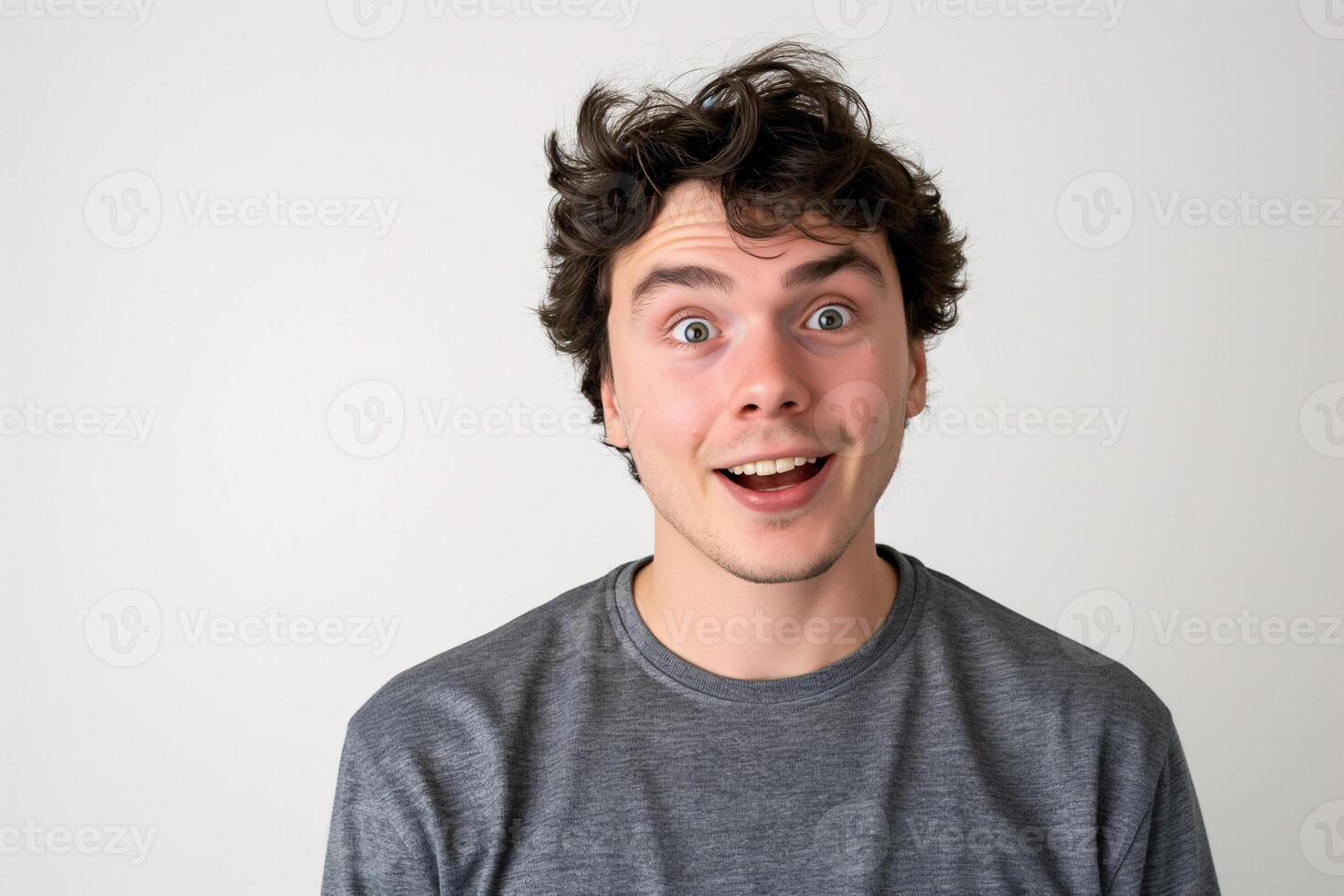 Young Man with Excited Expression in Grey Sweatshirt Isolated on White Background photo