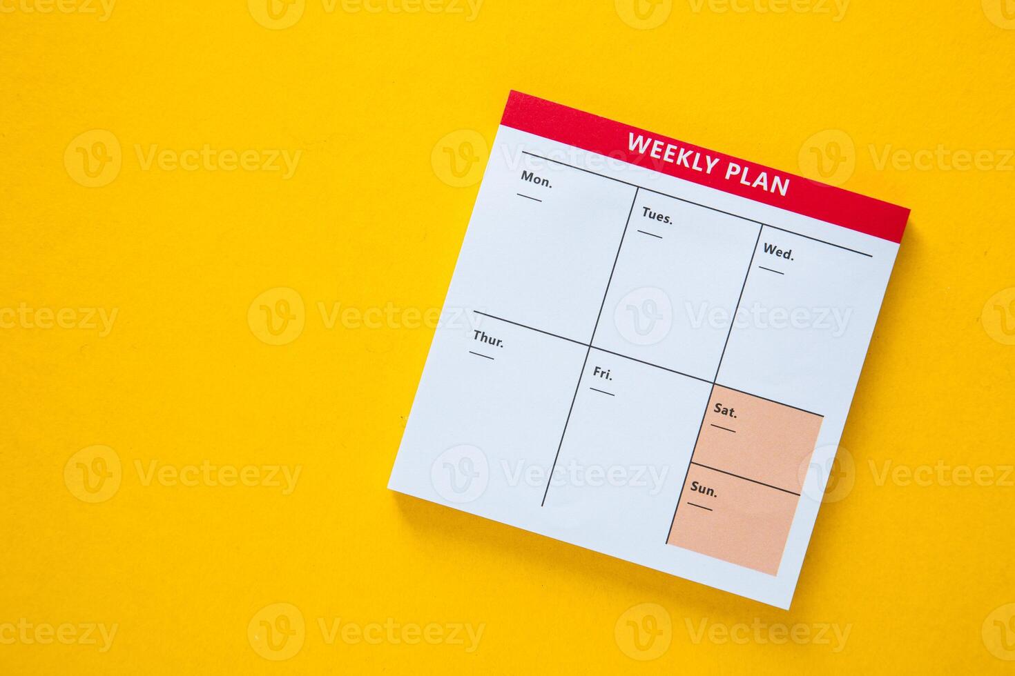 Colorful weekly planner with yellow background photo