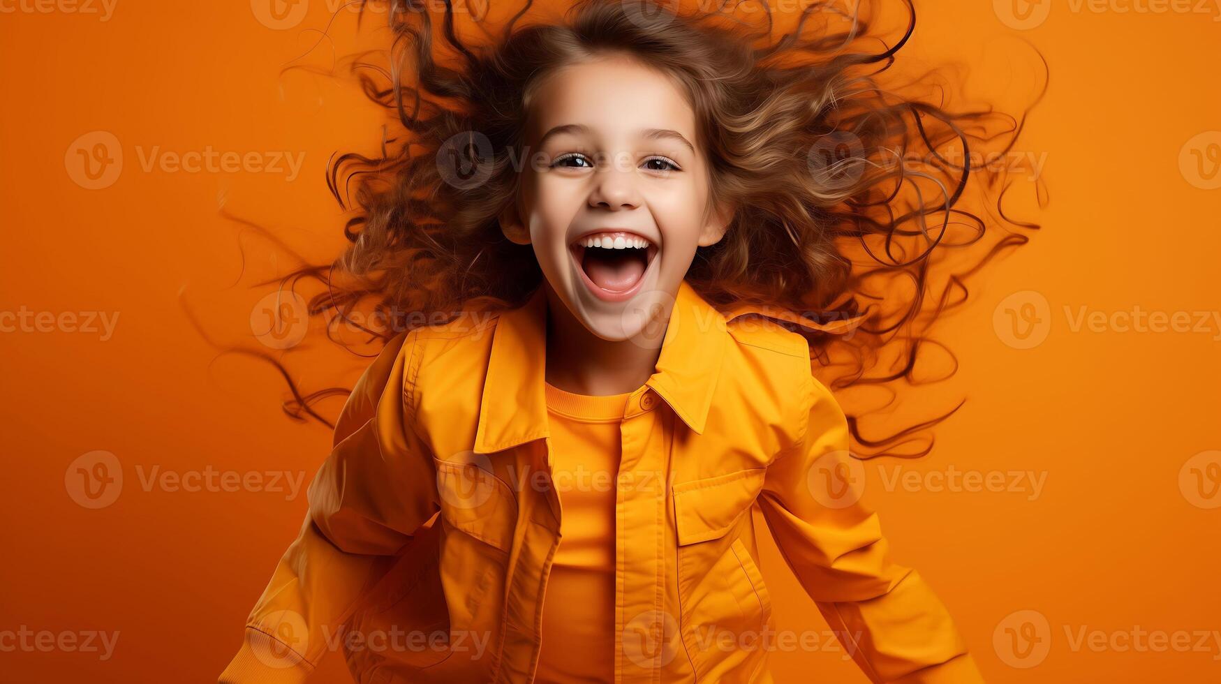Beautiful little girl smiling on the yellow background a happy child wearing a jacket photo