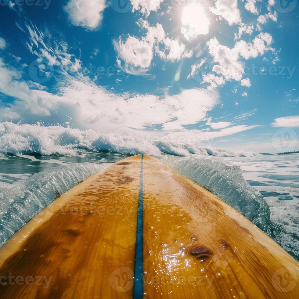 Surfboard against a clear blue sky. Breathtaking first-person view, dynamic footage of a surfer riding big waves along a tropical beach. photo