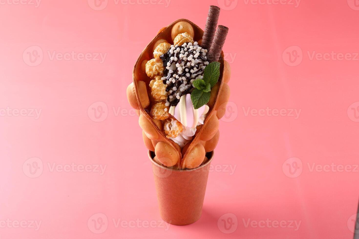 Hong kong or bubble waffle with ice cream and fruits isolated on white background photo