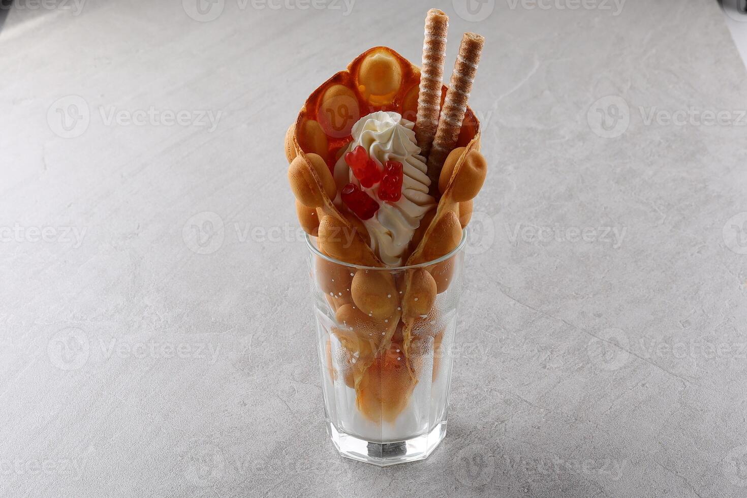 Hong kong or bubble waffle with ice cream and fruits isolated on white background photo