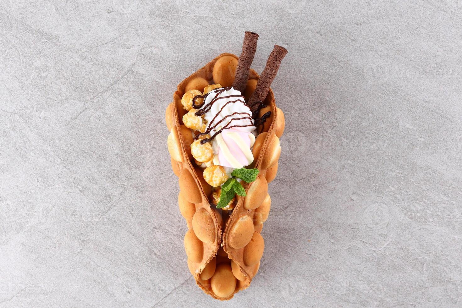 Hong kong or bubble waffle with ice cream and fruits isolated on white background photo