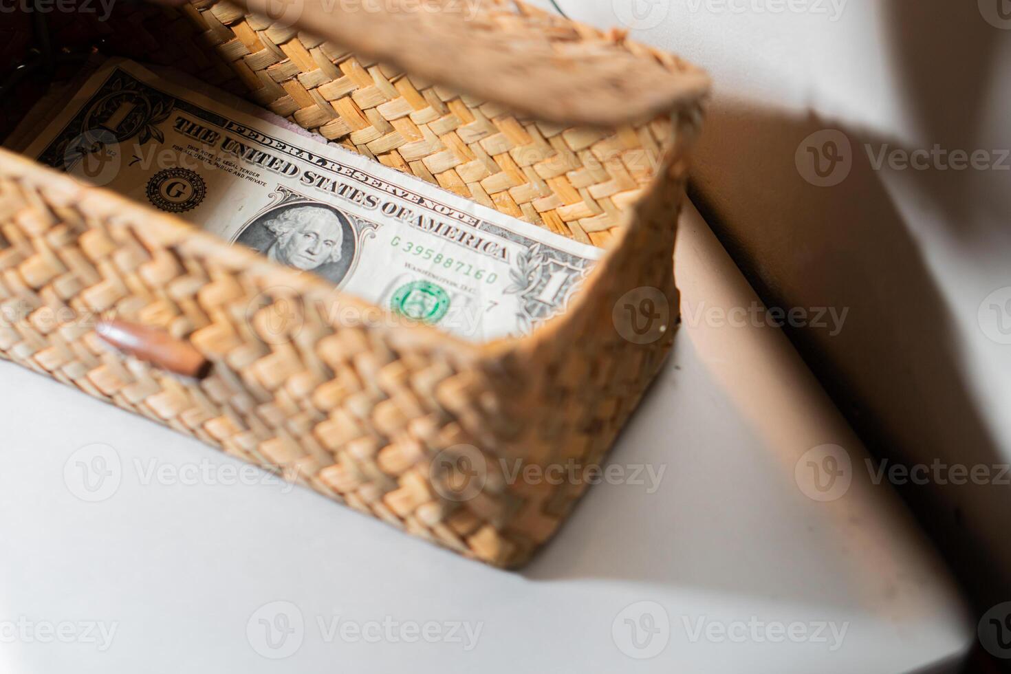 Woven basket with a one-dollar bill photo