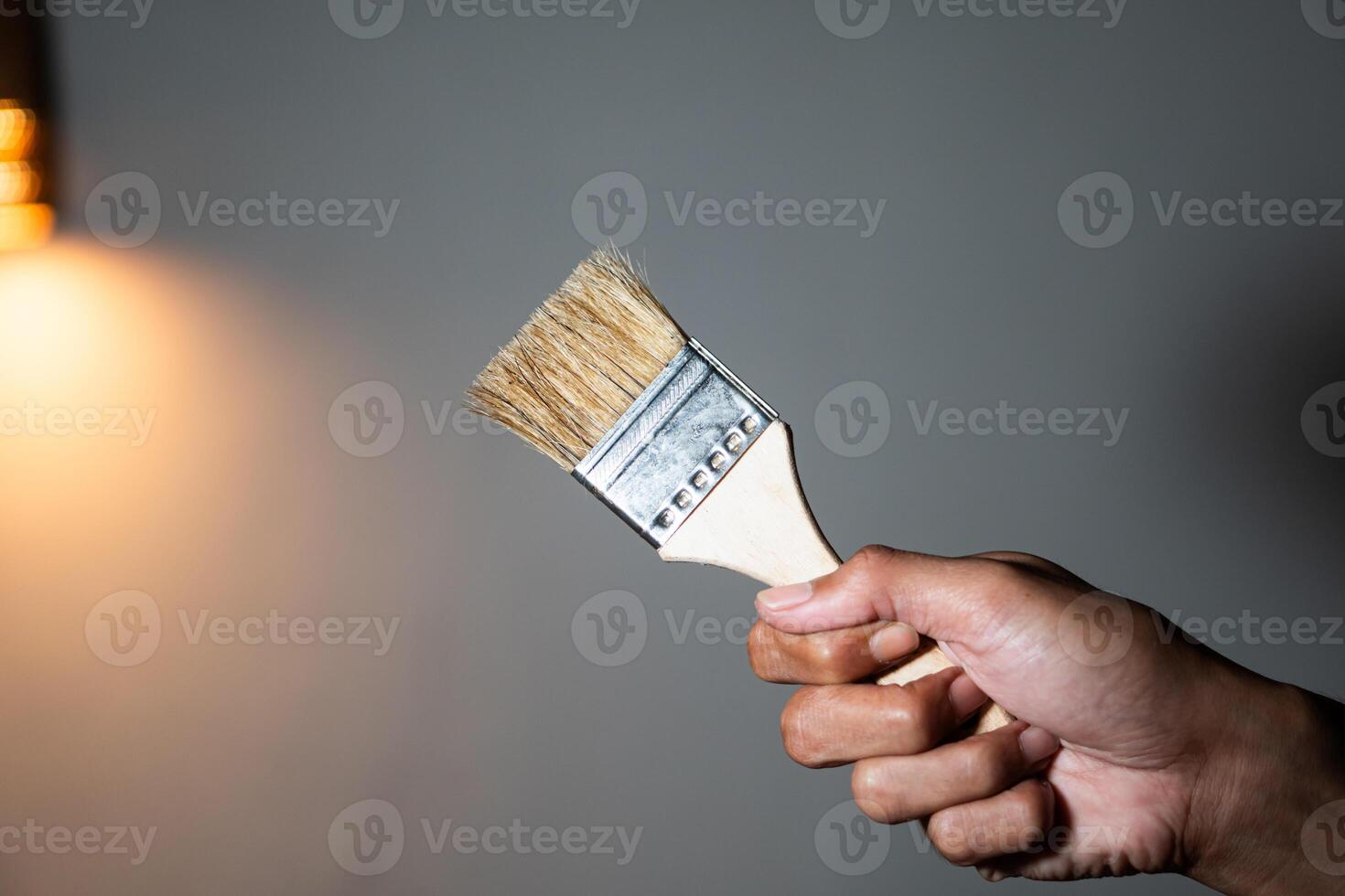 Hand holding a paintbrush photo