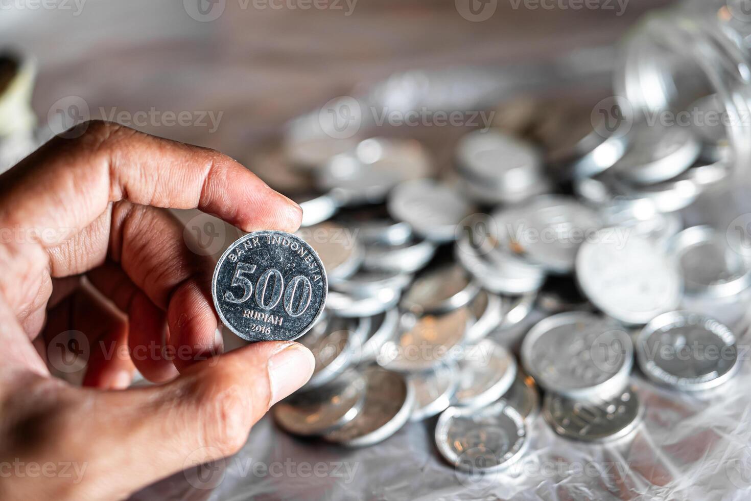 Hand Holding Indonesian 500 Rupiah Coin photo
