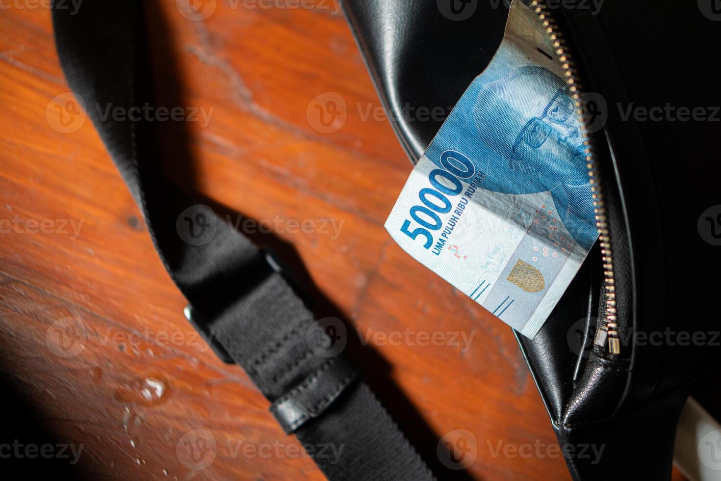 50000 Indonesian Rupiah banknote in a black bag photo