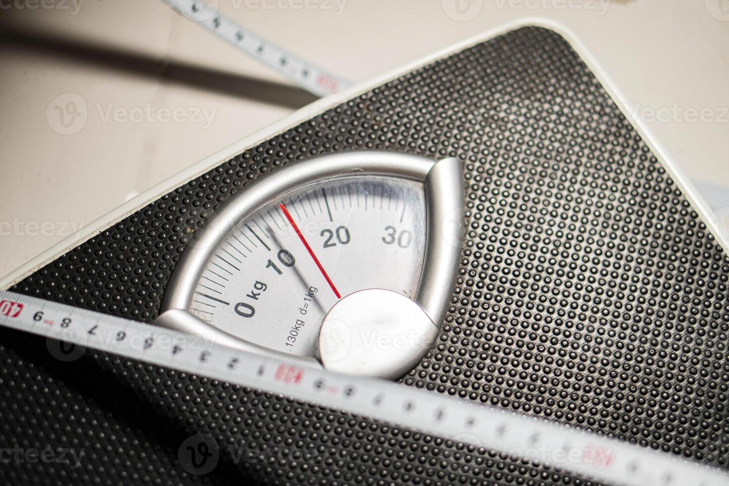 Mechanical bathroom scale with measuring tape photo