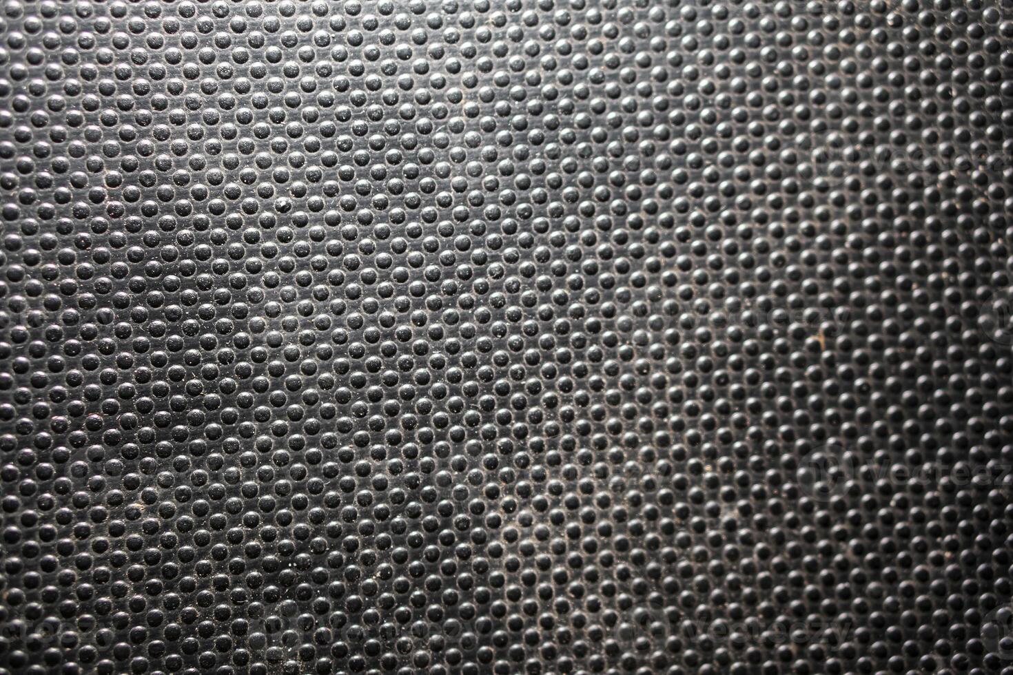 Textured black surface with circular bumps photo