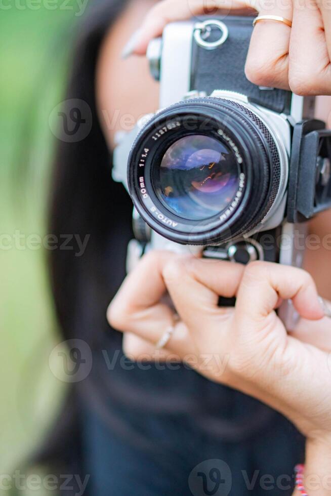 Person Holding a Vintage Camera photo