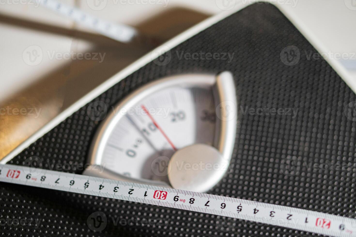 Mechanical bathroom scale with measuring tape photo