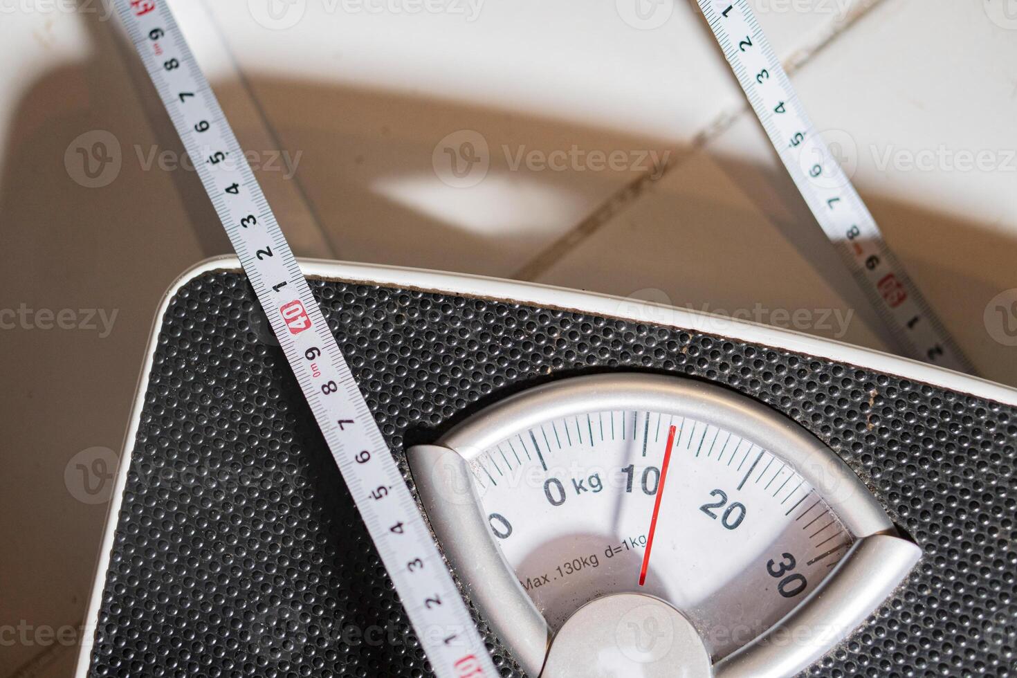 Mechanical bathroom scale with measuring tape photo