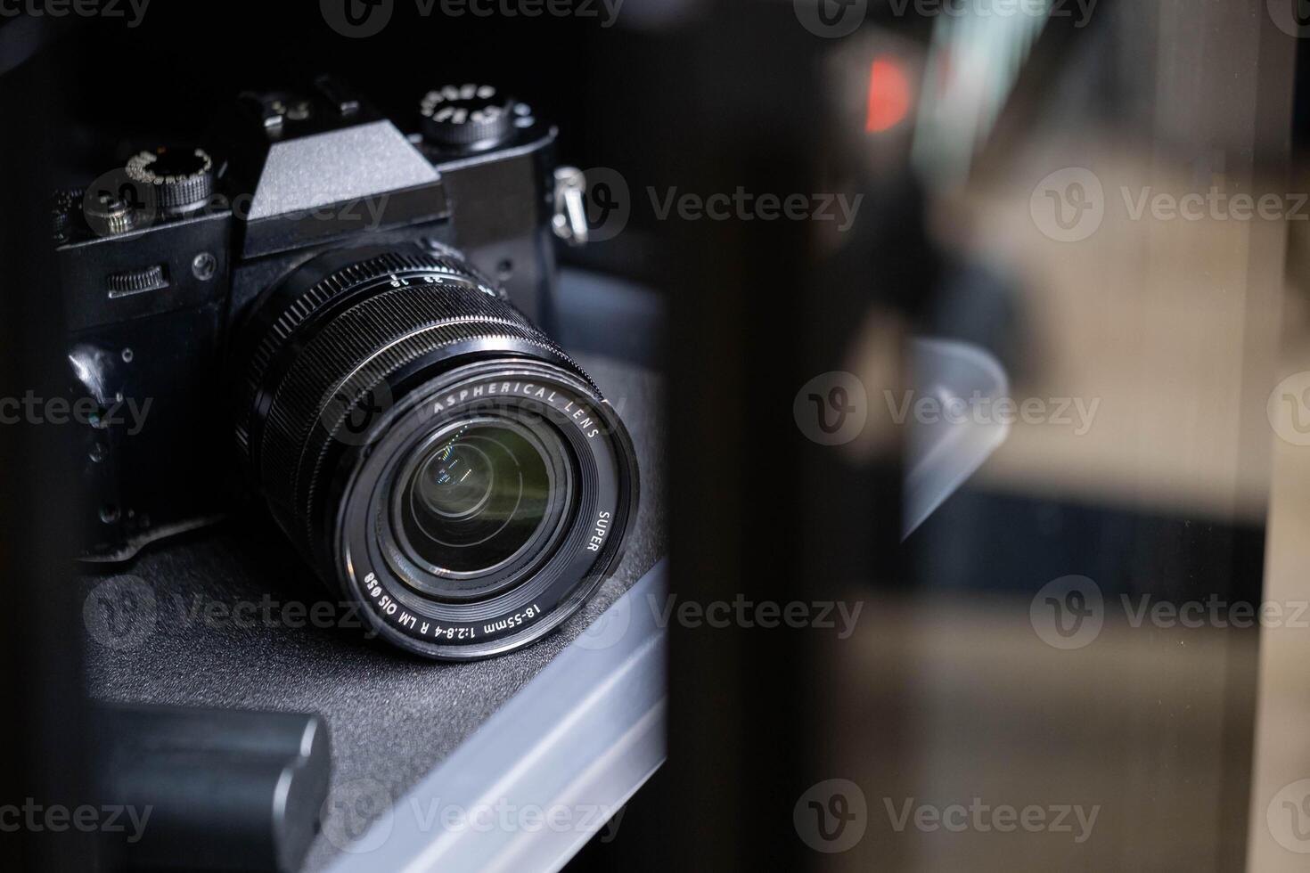 Black SLR Camera on Shelf photo