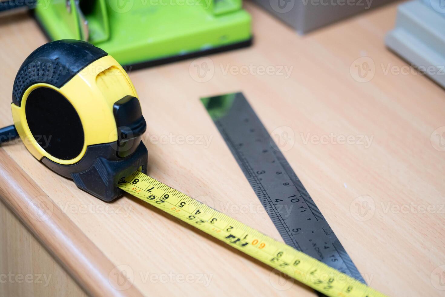 Tape measure and metal ruler on wooden desk photo