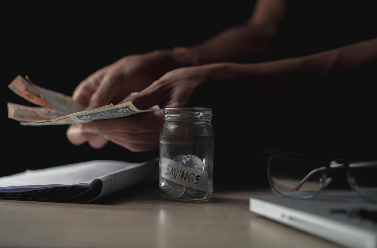 money saving business On a table in dark room. Money Saving Ideas for Financial Accounting photo