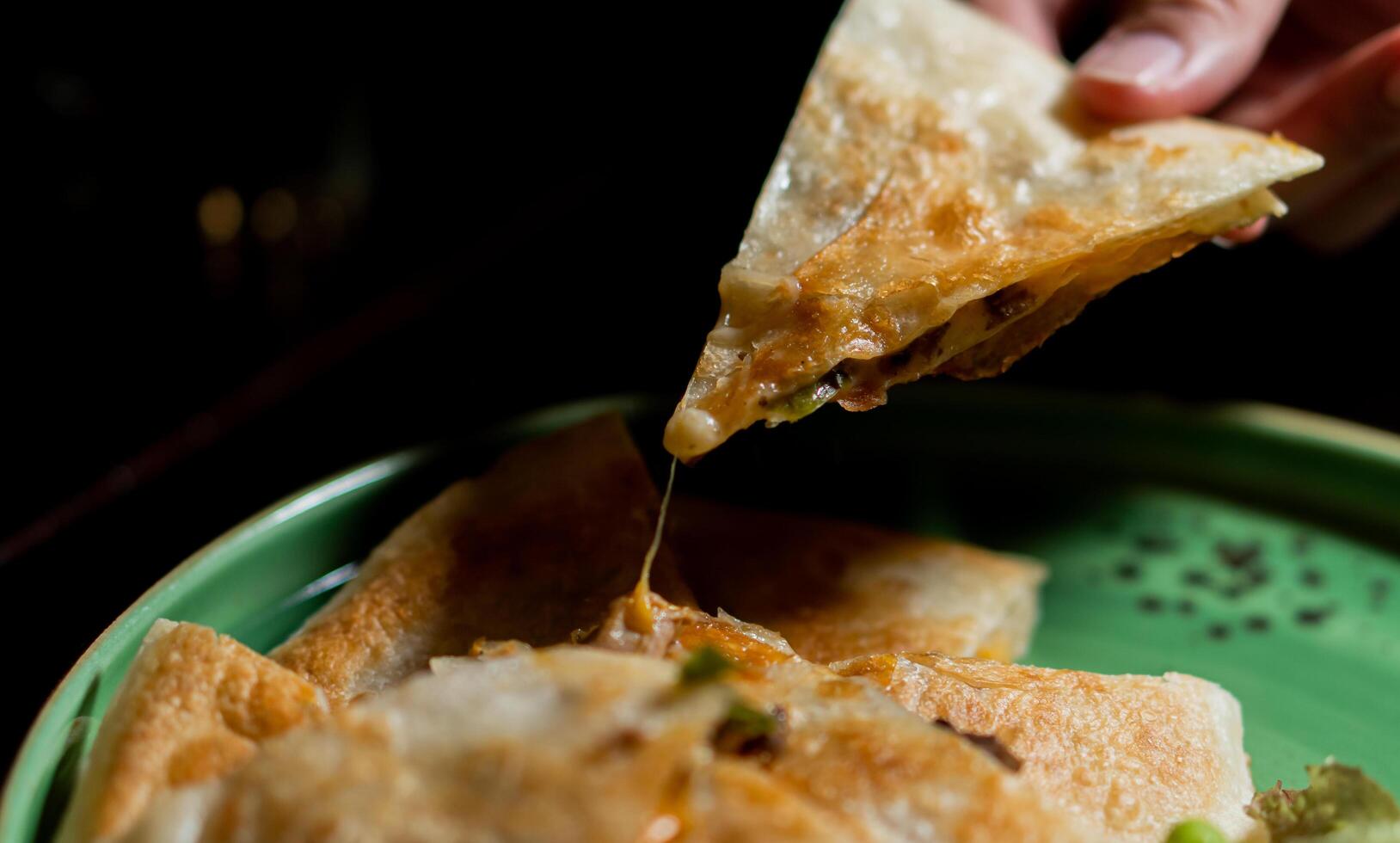 Italian Mozzarella Pizza On black Table, Top View , close up hand and laptop for working photo